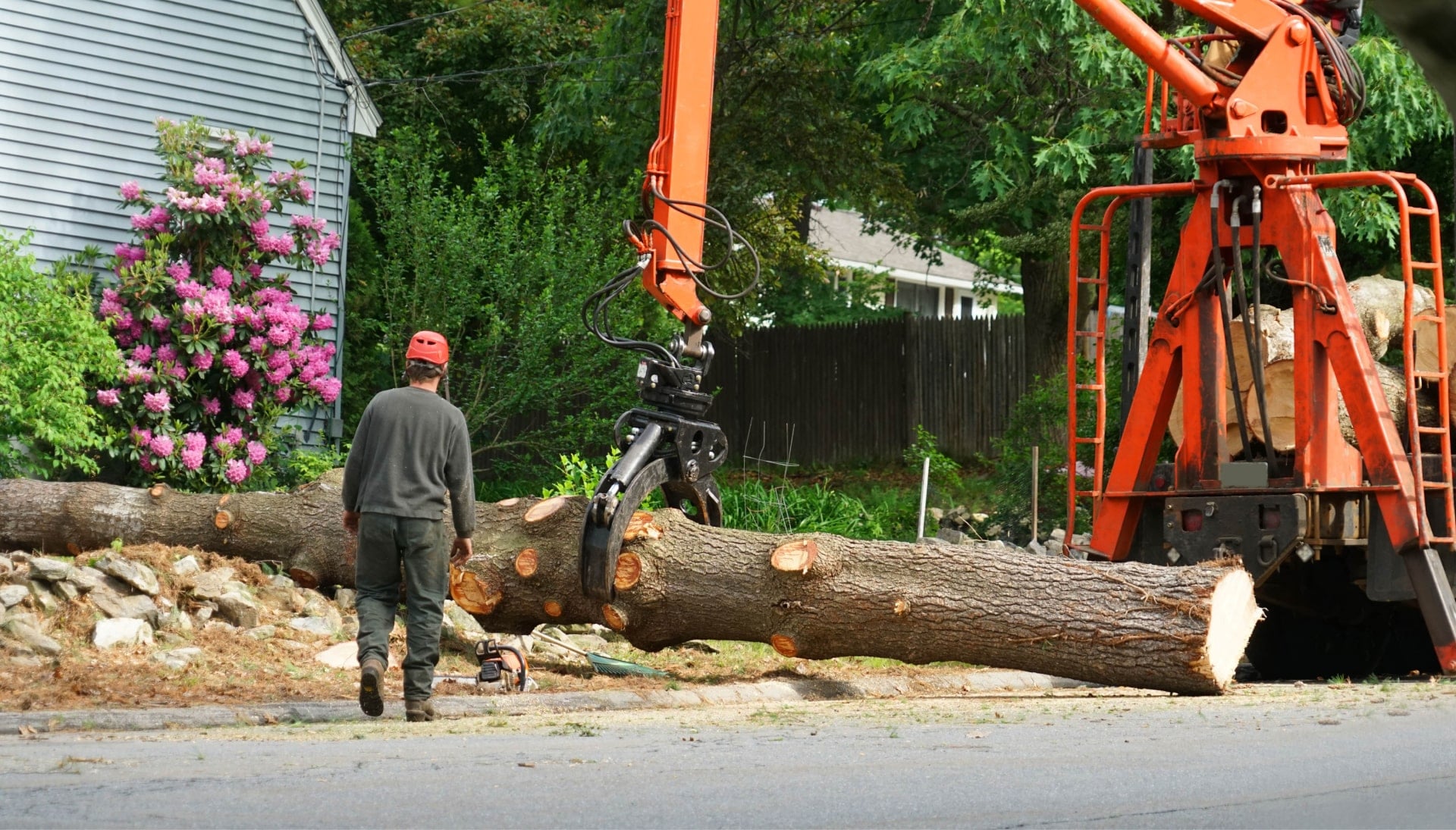 Expert tree removal service worker uses machine to pick up stump in Birmingham, Alabama